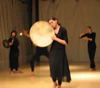 Catrina holding a drum close to her face