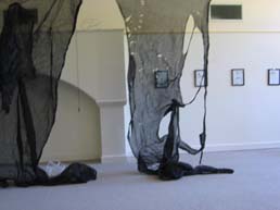 More torn black scrim pan right