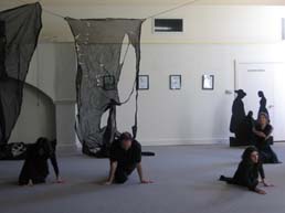 Trio on hands and knees on the stage