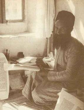 Black & white photo of a bearded scribe