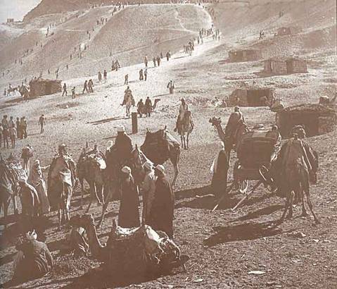 Middle Eastern desert Encampment with camels and travelers